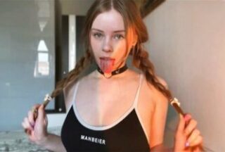 A young girl with pigtails gently sucks her boyfriend’s dick