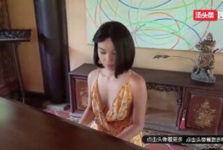 Pure goddess takes off her clothes and exposes herself naked next to the piano