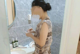 Godmother in a dress plays with her godson while wearing the clothes.